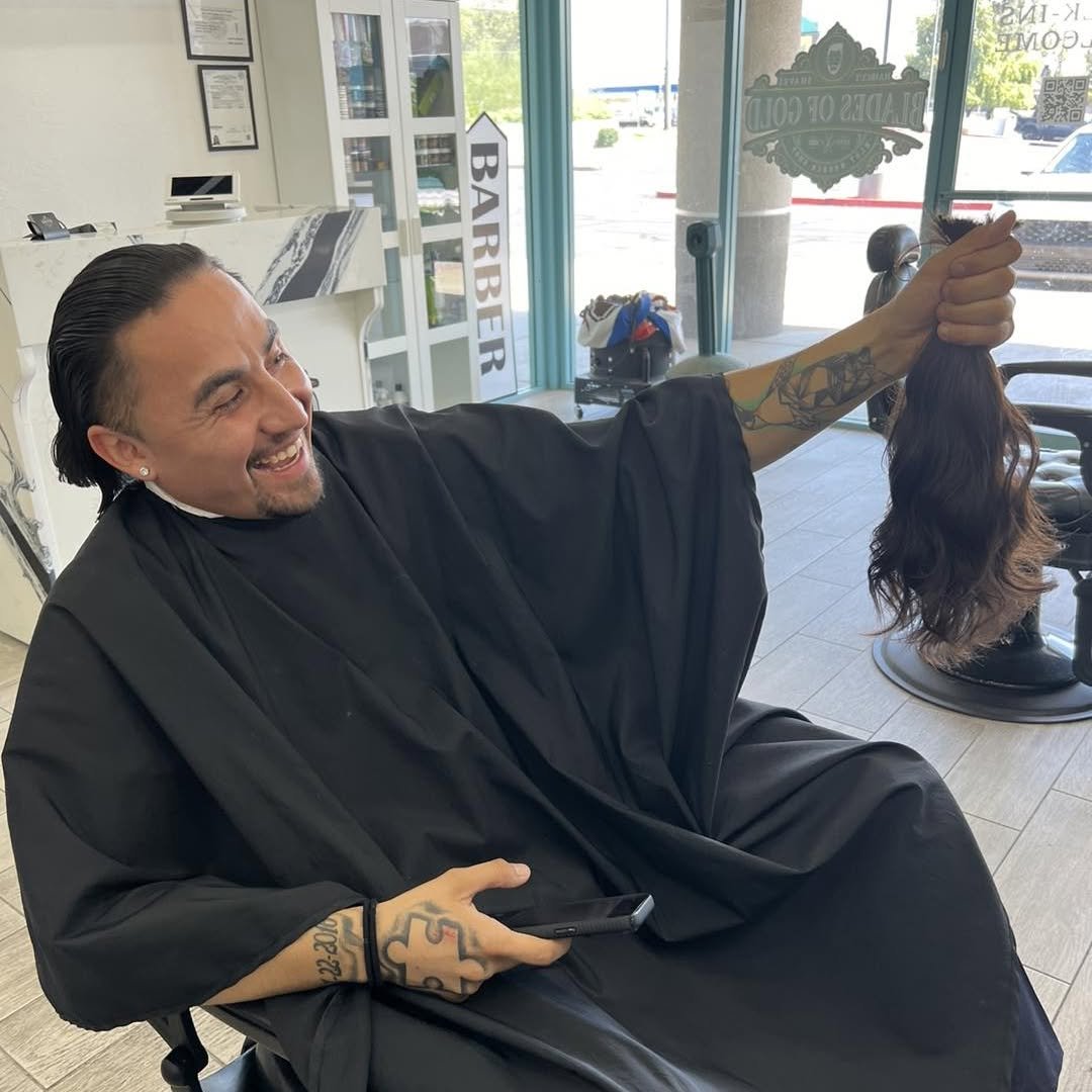 Client relaxing in the barber chair mid-service — Blades of Gold Barbershop, Phoenix AZ