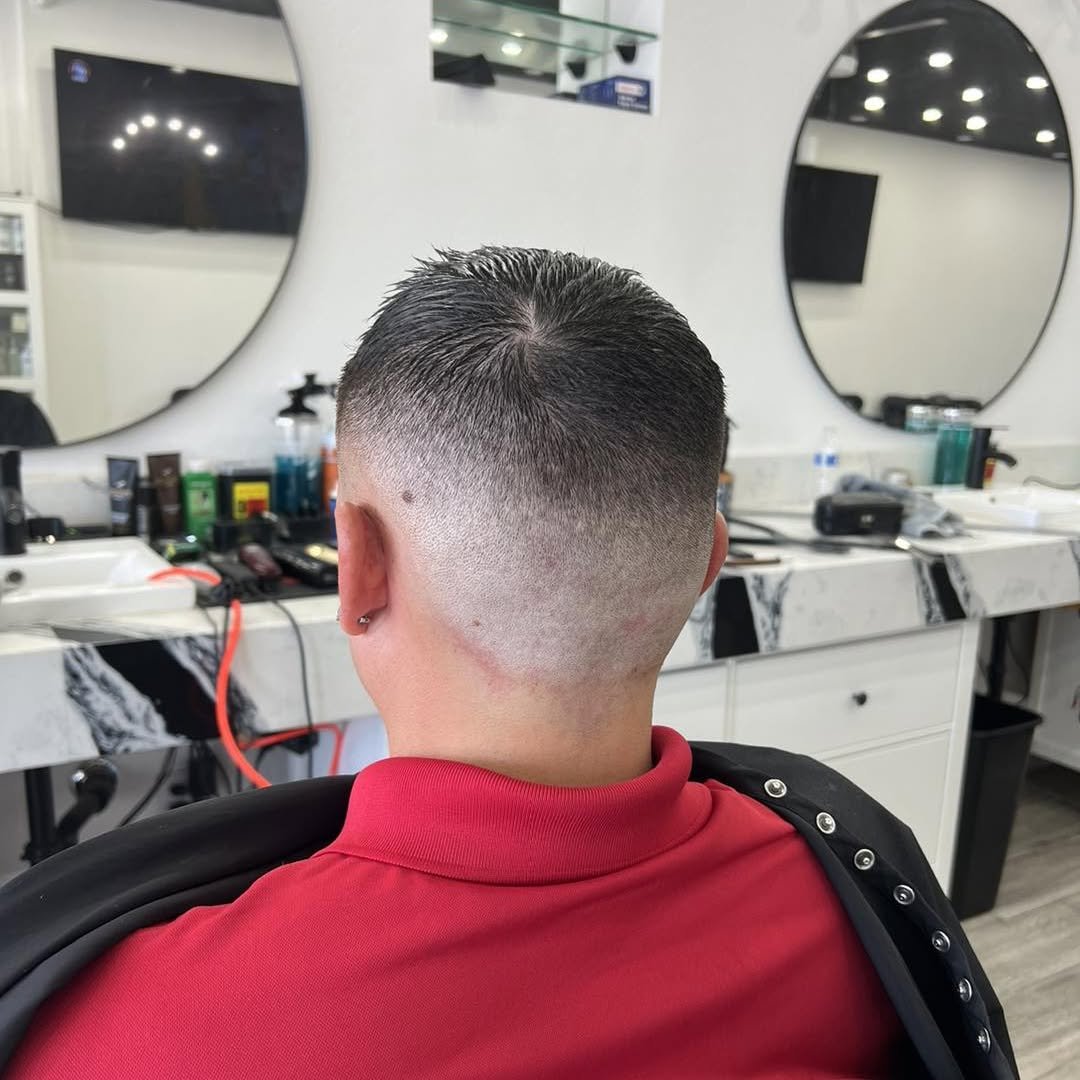 Low fade haircut with a clean neckline, back view — Blades of Gold Barbershop, Phoenix AZ
